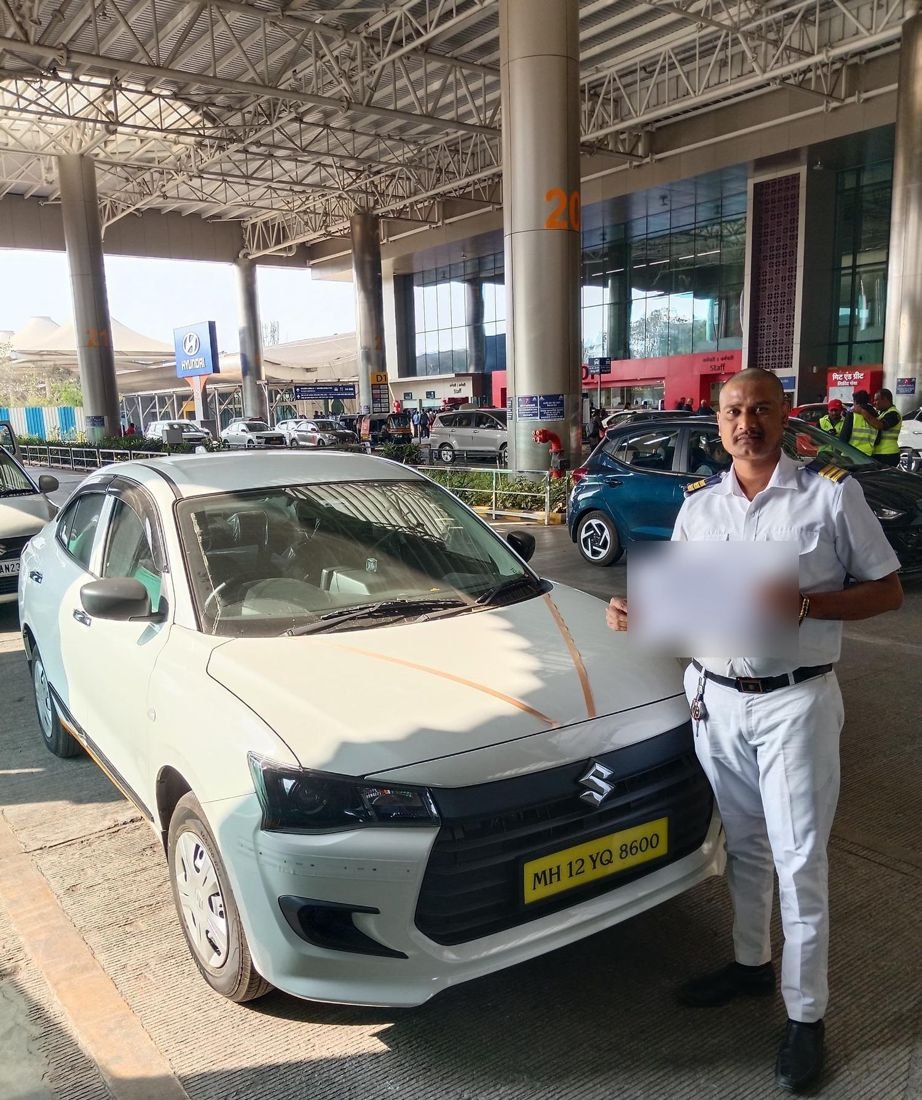 Gest Travels chauffeur with name board at Pune airport
